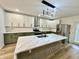 Bright kitchen featuring white and green cabinets, quartz countertops, and modern lighting at 1721 Thaddeus St, Indianapolis, IN 46203