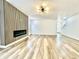 Spacious living room with hardwood floors, a modern fireplace, and minimalist lighting at 1721 Thaddeus St, Indianapolis, IN 46203