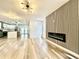 Open-concept living area with modern fireplace and hardwood floors, seamlessly connecting to the kitchen at 1721 Thaddeus St, Indianapolis, IN 46203