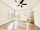 Bright, airy living room with modern flooring, a ceiling fan, and a view of the entrance at 1721 Thaddeus St, Indianapolis, IN 46203