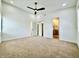 Spacious main bedroom with ensuite bathroom, walk-in closet, fan, and plush carpeting at 1721 Thaddeus St, Indianapolis, IN 46203