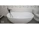 Close-up of a luxurious soaking tub with black faucet, adjacent to a modern toilet at 1737 W 1000 N, Alexandria, IN 46001
