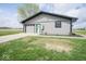 Charming exterior view of home with a garage, lovely gray siding, and a welcoming green door at 1737 W 1000 N, Alexandria, IN 46001