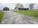 Inviting exterior view of home and detached garage with long driveway at 1737 W 1000 N, Alexandria, IN 46001