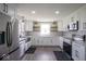 Bright kitchen with stainless steel appliances, white cabinets, and stylish wood-look flooring at 1737 W 1000 N, Alexandria, IN 46001