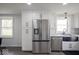 Bright kitchen showcasing stainless steel refrigerator and a black farmhouse sink at 1737 W 1000 N, Alexandria, IN 46001