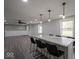 Open concept: island with granite counter top, stylish lighting, and sleek black bar stools at 1737 W 1000 N, Alexandria, IN 46001