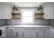 Stylish kitchen showcasing granite countertops, white cabinets, and floating wood shelves at 1737 W 1000 N, Alexandria, IN 46001