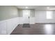 Living room with gray flooring, white door, paneled walls and window at 1737 W 1000 N, Alexandria, IN 46001