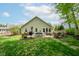 Spacious backyard featuring a deck with a dining set, perfect for outdoor entertaining and summer BBQs at 19519 Creekview Dr, Noblesville, IN 46062
