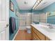 Well-lit bathroom featuring a shower-tub combo, wood-look flooring, and large vanity with ample counter space at 19519 Creekview Dr, Noblesville, IN 46062