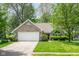 Charming single-story brick home featuring an attached two-car garage and a well-manicured front lawn at 19519 Creekview Dr, Noblesville, IN 46062