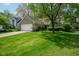 Attractive single-story brick home showcasing a lush green lawn and mature trees shading the property at 19519 Creekview Dr, Noblesville, IN 46062