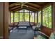Comfortable screened-in gazebo featuring a ceiling fan, wicker furniture and views of lush greenery for relaxing outdoors at 19519 Creekview Dr, Noblesville, IN 46062