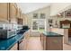 Functional kitchen showcases wood floors, abundant wood cabinets, black appliances, and green countertops at 19519 Creekview Dr, Noblesville, IN 46062