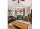 Cozy living room featuring a fireplace, built-in bookshelves, and comfortable leather seating at 19519 Creekview Dr, Noblesville, IN 46062