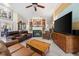 Comfortable living room showcasing a green-tiled fireplace, built-in bookshelves, and ample seating at 19519 Creekview Dr, Noblesville, IN 46062