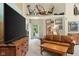 Inviting living room features a leather sofa, wooden coffee table, and bright natural light at 19519 Creekview Dr, Noblesville, IN 46062