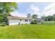 Expansive backyard with lush green grass and mature trees, offering a peaceful retreat at 2237 W 100 N, Greenfield, IN 46140