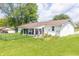 Wide backyard featuring lush green grass, mature trees, and a charming screened-in porch at 2237 W 100 N, Greenfield, IN 46140