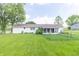 Expansive backyard featuring lush green grass and mature trees at 2237 W 100 N, Greenfield, IN 46140