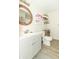 Bright bathroom with white vanity, round mirror, and open shelving, creating a clean and modern spa-like retreat at 2237 W 100 N, Greenfield, IN 46140