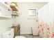 Bright bathroom featuring a floating shelf, a window and a floral shower curtain at 2237 W 100 N, Greenfield, IN 46140