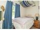 Comfortable bedroom with soft, natural light and stylish blue curtains at 2237 W 100 N, Greenfield, IN 46140
