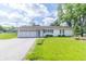 Charming single-story home featuring a two car garage and a well manicured lawn at 2237 W 100 N, Greenfield, IN 46140