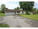 Charming ranch home featuring an attached two-car garage, landscaping, and paved driveway at 2237 W 100 N, Greenfield, IN 46140