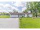 Charming home featuring a two-car garage, a welcoming front porch, and a well-manicured lawn at 2237 W 100 N, Greenfield, IN 46140