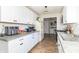 Bright kitchen featuring white cabinetry, granite countertops, and wood-look vinyl floors, perfect for cooking and entertaining at 2237 W 100 N, Greenfield, IN 46140