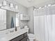 Bathroom featuring a gray vanity, white toilet and shower with white shower curtain at 2403 N Delaware St, Indianapolis, IN 46205