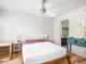 Bright bedroom featuring a ceiling fan, hardwood floors, and a blue antique dresser at 2403 N Delaware St, Indianapolis, IN 46205