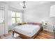Bright bedroom featuring a ceiling fan, hardwood floors, and lots of natural light at 2403 N Delaware St, Indianapolis, IN 46205