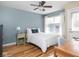Cozy bedroom with a ceiling fan, large window, and neutral decor at 2403 N Delaware St, Indianapolis, IN 46205