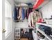 Organized closet featuring hanging clothes, shoes, and storage bins at 2403 N Delaware St, Indianapolis, IN 46205
