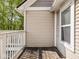 A wood deck featuring white wood railings with tan vinyl siding on the house at 2403 N Delaware St, Indianapolis, IN 46205