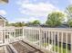 A wood deck featuring white wood railings overlooking the property at 2403 N Delaware St, Indianapolis, IN 46205