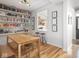 Dining area featuring a wooden table, stylish seating, and a view of the adjacent kitchen at 2403 N Delaware St, Indianapolis, IN 46205