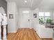 Bright entryway with hardwood floors, neutral walls, and views into the adjacent living space at 2403 N Delaware St, Indianapolis, IN 46205