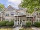Charming townhome featuring a double balcony, well-maintained landscaping, and a welcoming front entrance at 2403 N Delaware St, Indianapolis, IN 46205