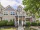 Charming townhome featuring a double balcony, well-maintained landscaping, and a welcoming front entrance at 2403 N Delaware St, Indianapolis, IN 46205