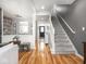 A light-filled foyer offers warm hardwood floors, white railings, and gray accent walls at 2403 N Delaware St, Indianapolis, IN 46205