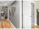 The hallway features hardwood flooring, freshly painted walls, and custom shelving at 2403 N Delaware St, Indianapolis, IN 46205