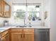 The kitchen area has wood cabinets, stone countertops, and a stainless steel dishwasher at 2403 N Delaware St, Indianapolis, IN 46205