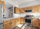 The kitchen has updated appliances, shaker cabinets, and tile flooring at 2403 N Delaware St, Indianapolis, IN 46205