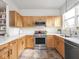 The kitchen is beautifully updated with wood cabinets and stainless steel appliances at 2403 N Delaware St, Indianapolis, IN 46205