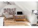 Bright living room with a bookshelf, television, and hardwood floors at 2403 N Delaware St, Indianapolis, IN 46205