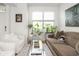 Comfortable living room with large windows, stylish decor, and hardwood floors at 2403 N Delaware St, Indianapolis, IN 46205